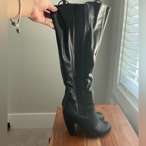 Black leather under the knee high boots